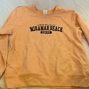 peach sweatshirt